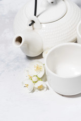 white pialat, tea and jasmine. japanese tea party, vertical top view