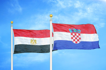 Egypt and Croatia two flags on flagpoles and blue cloudy sky