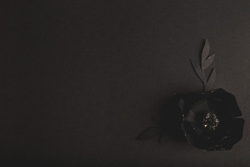 black background with a beautiful gold glittering flowers made of paper