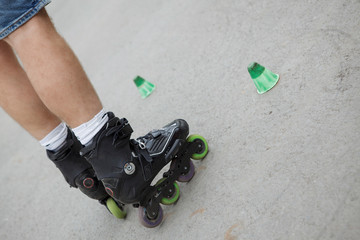 inline skates moving through a skatepark. freestyle slalom
