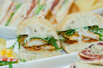 A selection of various sandwiches and fillings, garnished with crisps and salad.
