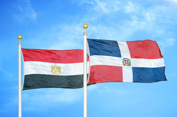 Egypt and Dominican Republic two flags on flagpoles and blue cloudy sky