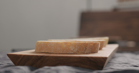 ciabatta slices on olive wood board closeup