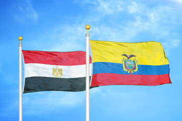 Egypt and Ecuador two flags on flagpoles and blue cloudy sky