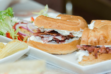 A selection of various sandwiches and fillings, garnished with crisps and salad.
