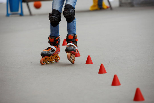 inline skates moving through a skatepark. freestyle slalom