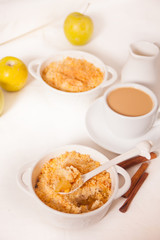 Tasty homemade apple crumble dessert on the white background.