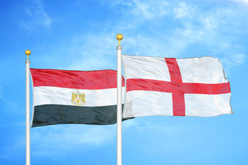 Egypt and England two flags on flagpoles and blue cloudy sky