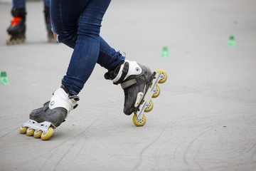 inline skates moving through a skatepark. freestyle slalom