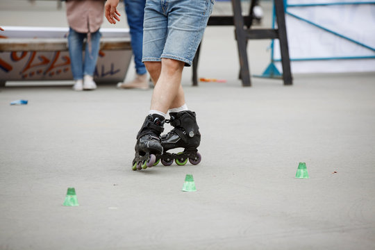 inline skates moving through a skatepark. freestyle slalom