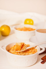 Tasty homemade apple crumble dessert on the white background.