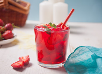 Glass with fresh homemade strawberry sweet iced tea or cocktail, lemonade with mint. Refreshing cold drink. Summer pool party. Marine theme.