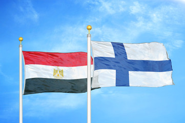 Egypt and Finland two flags on flagpoles and blue cloudy sky