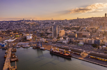 Obraz premium Haifa cargo harbor and cityscape at sunset aerial view