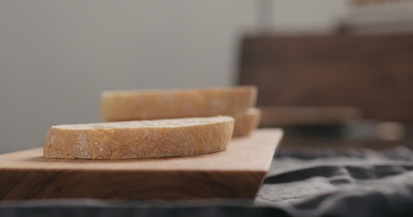 ciabatta slices on olive wood board closeup