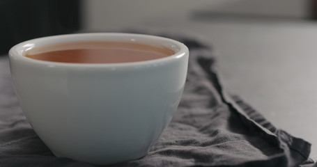 black tea in white cup closeup with copy space