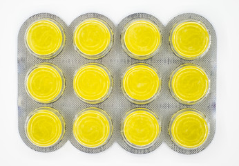 Pharmaceutical  yellow pills in blisters on white background