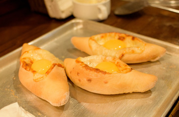 Ready khachapuri on a baking sheet. Top view