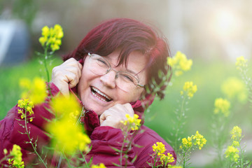 A laughing happy mother, Mother's Day image. Red-haired old woman smiling.