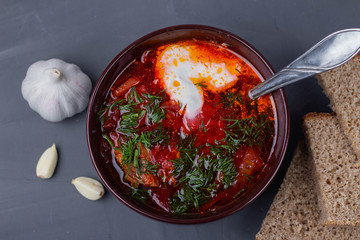 Russian borscht with sour cream, garlic and bread
