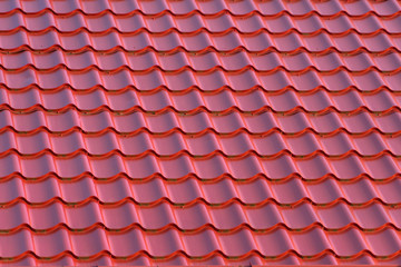 Roof of a house with modern red metal roof tiles