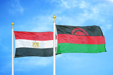 Egypt and Malawi two flags on flagpoles and blue cloudy sky