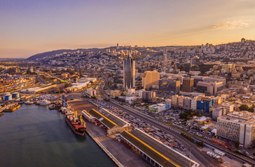 Haifa cargo harbor and cityscape at sunset aerial view