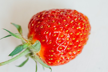 Fresh strawberry close-up on a white background