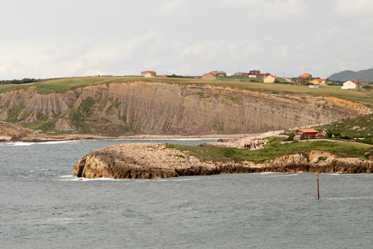 view of the shore and the sea of suances cantabria spain waves sand risks houses lonely nature