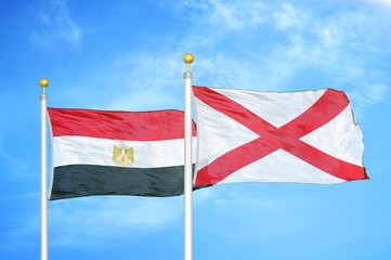 Egypt and Northern Ireland two flags on flagpoles and blue cloudy sky