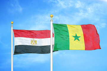 Egypt and Senegal two flags on flagpoles and blue cloudy sky