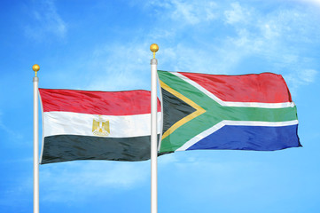 Egypt and South Africa two flags on flagpoles and blue cloudy sky