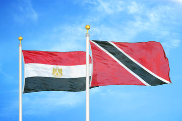 Egypt and Trinidad and Tobago two flags on flagpoles and blue cloudy sky