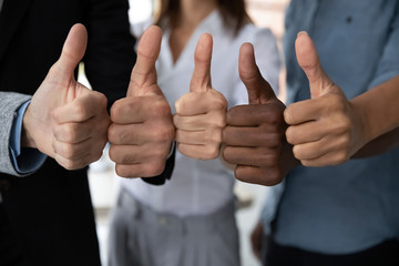 Close up view of diverse business team people hands showing thumbs up like finger gesture recommendation or good job choice. Professional multicultural team recommend corporate service. - obrazy, fototapety, plakaty
