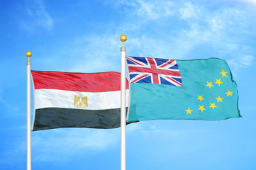 Egypt and Tuvalu two flags on flagpoles and blue cloudy sky