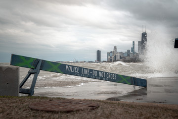 Chicago skyline view with blue wooden police barricades blocking off the lakefront trail or bike...