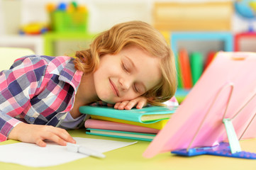 Close up portrait of cute schoolgirl sleeping on table