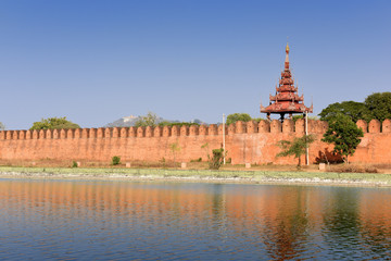 Landscape Ancient brown brick Palace wall with reflection in the canal surrounding the Mandalay...