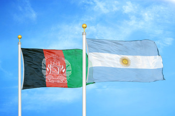Afghanistan and Argentina   two flags on flagpoles and blue cloudy sky