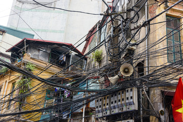 Hundreds of electrical cables are strewn over an electricity pole in a dangerous way in Hanoi,...
