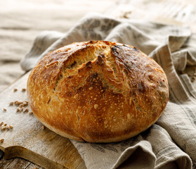 Artisan sourdough bread made using traditional methods on wooden board
