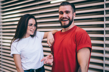 Trendy cheerful millennial friends having funny discussion