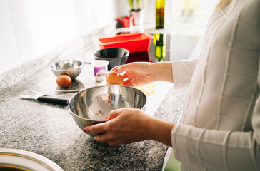 Woman prepares the ingredients to make a sponge cake