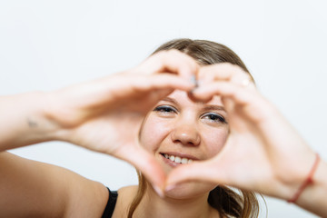 Fototapeta premium woman making a hand heart frame