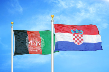 Afghanistan and Croatia  two flags on flagpoles and blue cloudy sky
