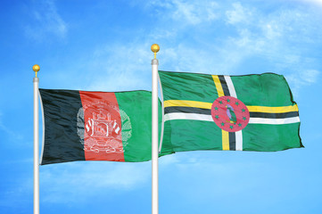 Afghanistan and Dominica  two flags on flagpoles and blue cloudy sky