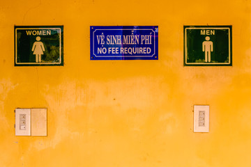 Signs at a public toilet advising that no fee is required to use them.