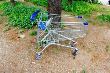 A supermarket shopping cart parked under a tree in Athens, Greece, March 22 2020.