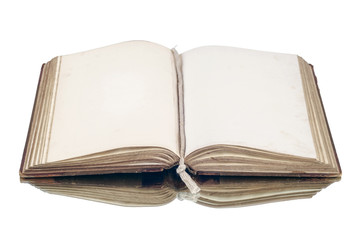 An old vintage open book reflecting on a white surface