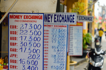 Signs with exchange rates outside a bureau de change money exchange in Hoi An, Vietnam